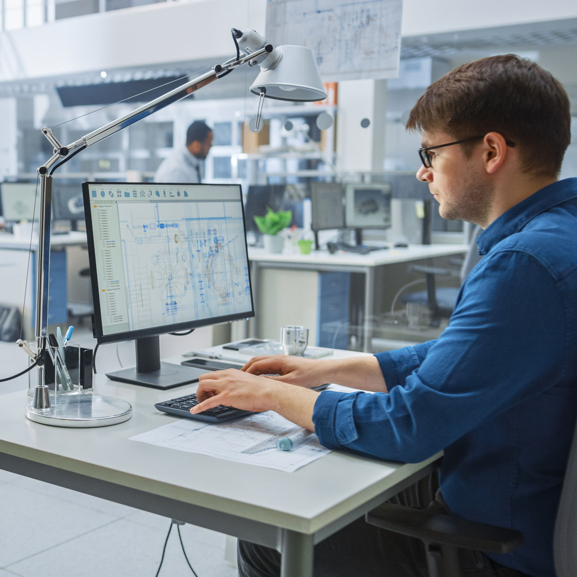 In the Busy Engineering Facility: Diverse Group of Engineers, Technicians, Working on Design for Industrial Engine Prototype. Specialists Talk During Meetings, Work with Drawings, Use Computers